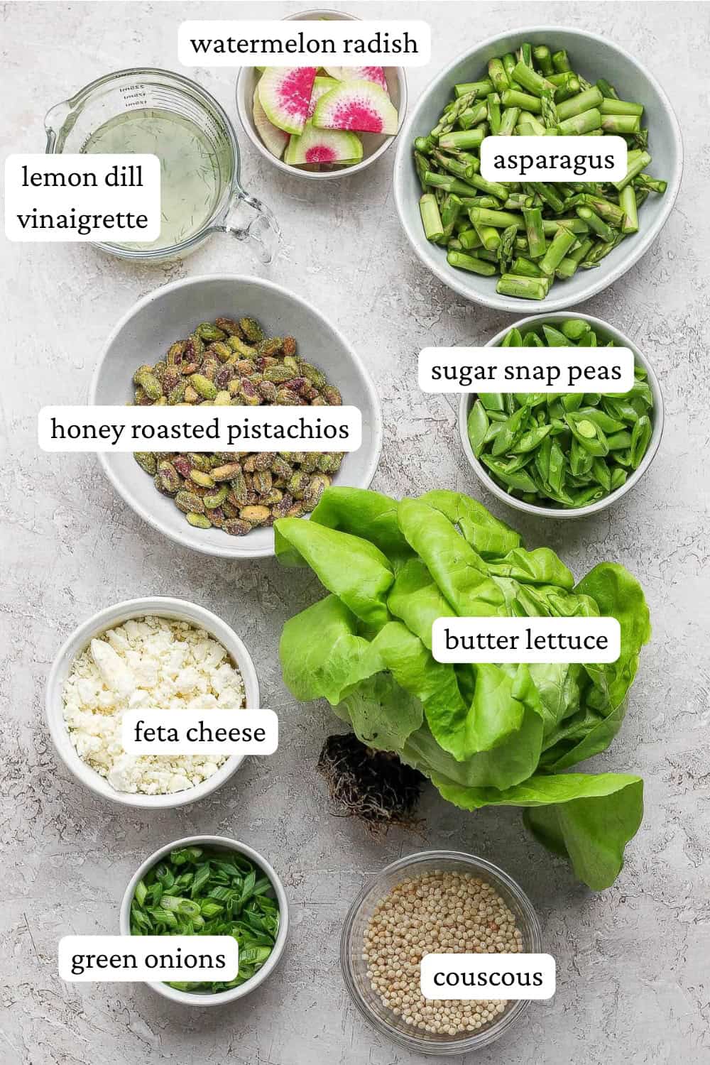 Ingredients for a spring salad with couscous and peas with labels.