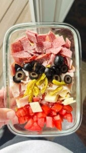 Sub in a tub in a glass meal prep container being held by a hand.