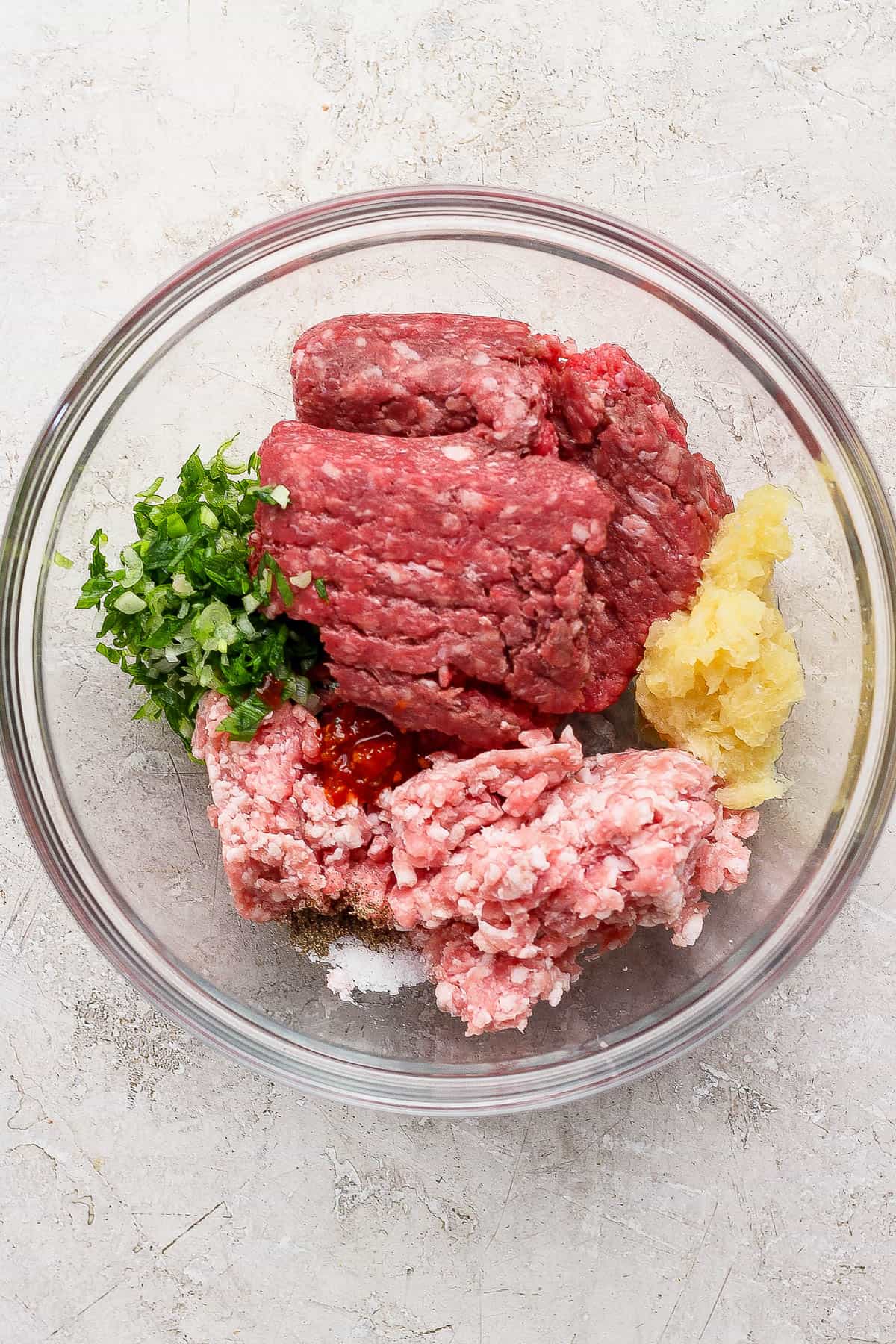 Pineapple teriyaki meatball ingredients unmixed in a bowl.