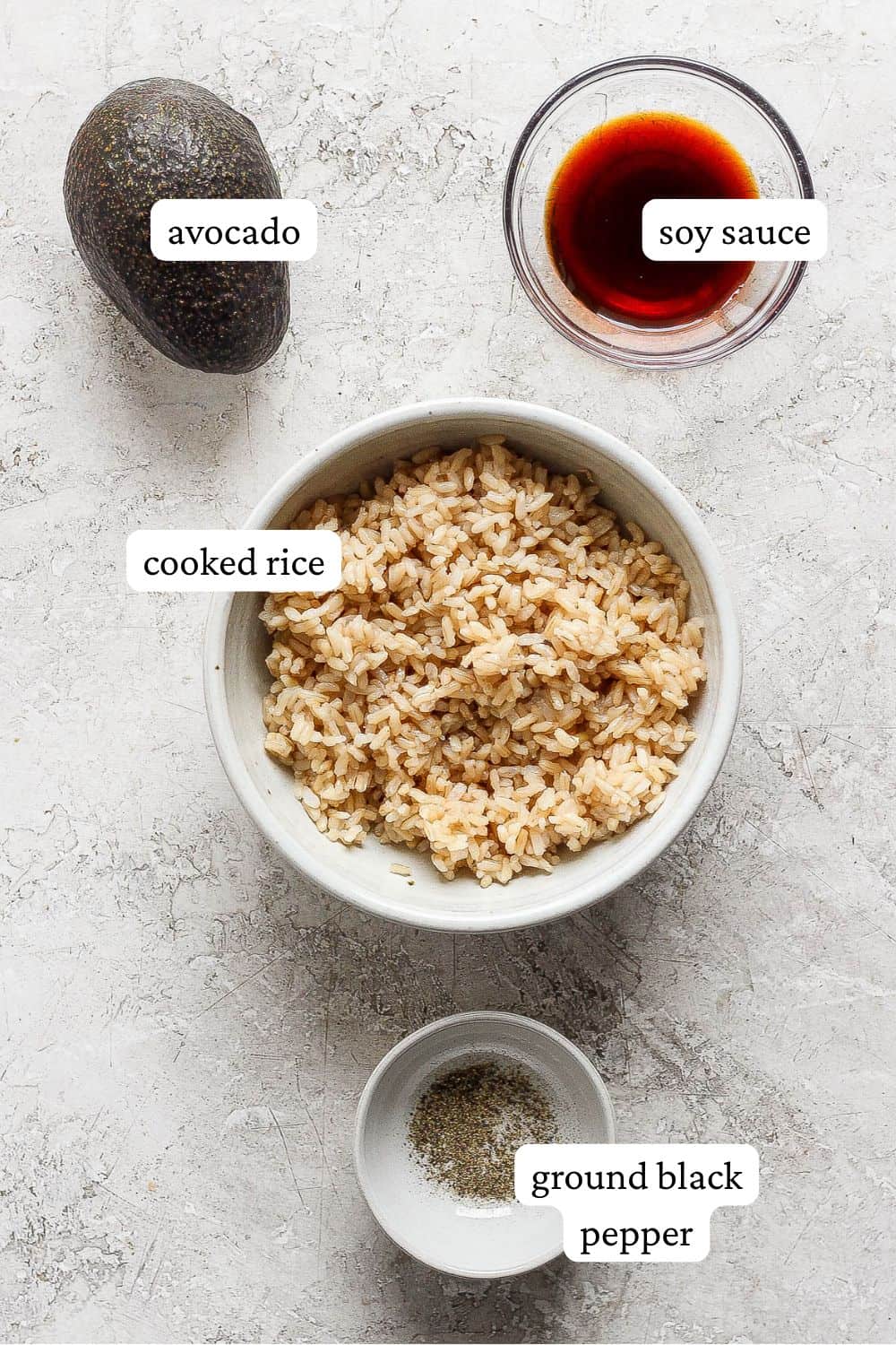 Ingredients for an avocado rice bowl in separate bowls.