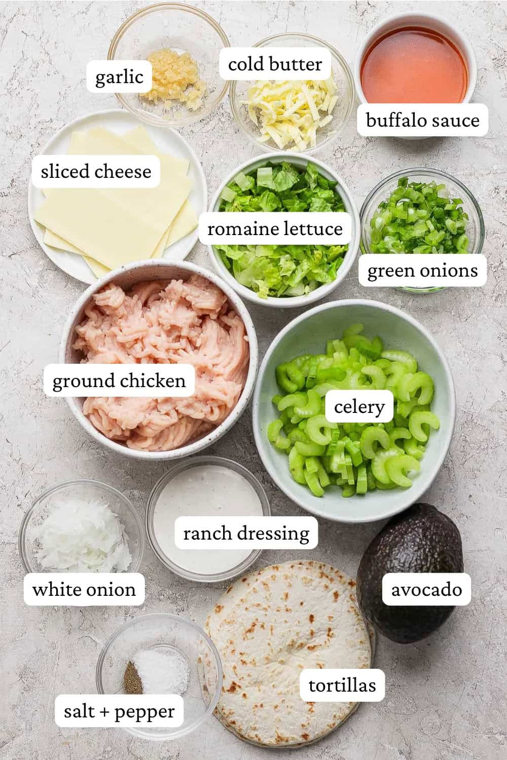 Ingredients for buffalo chicken smash tacos in separate bowls with labels.