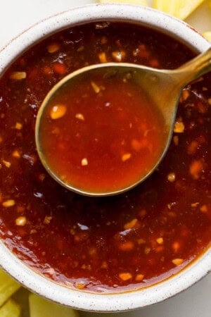 Pineapple teriyaki sauce in a bowl with a spoon