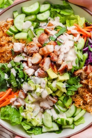 Bang bang chicken salad with crispy rice in a serving bowl.