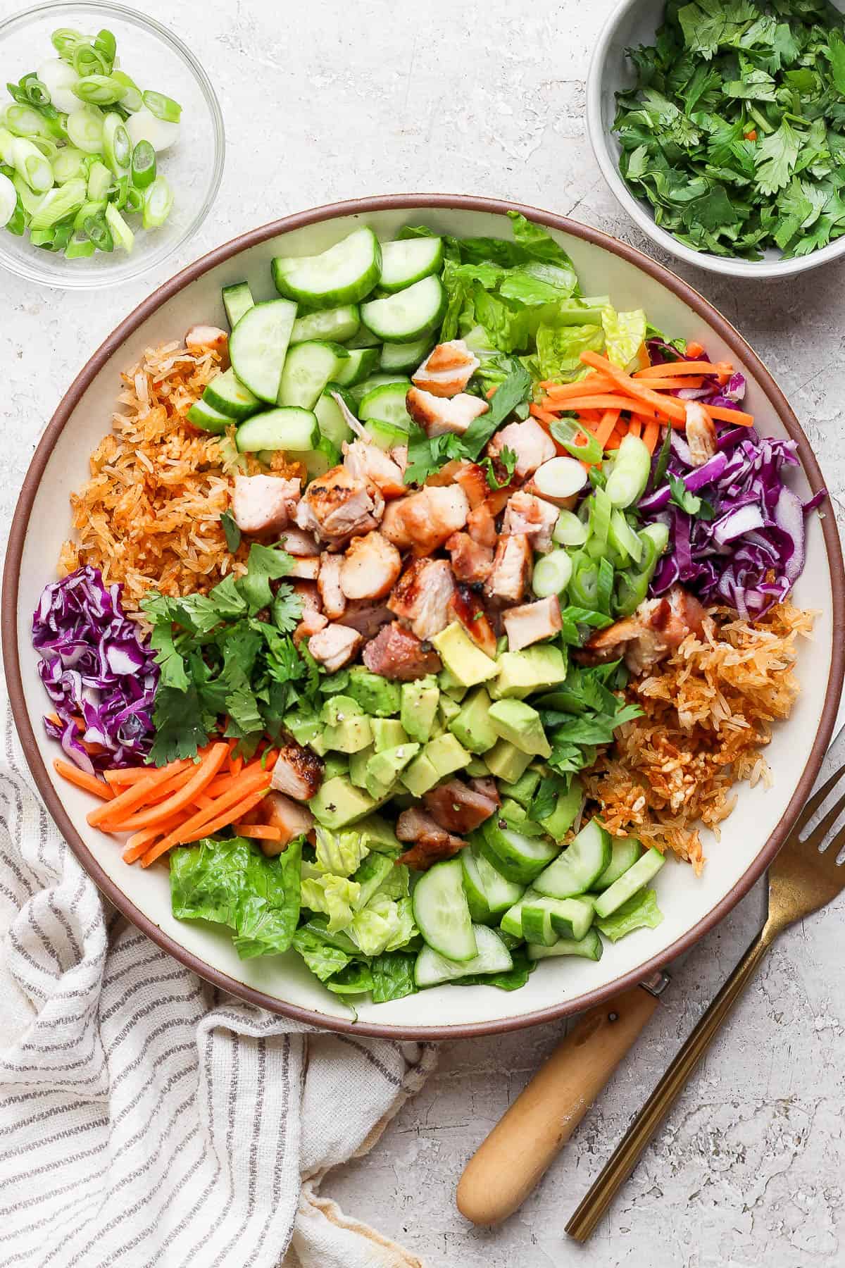 Bang bang chicken salad with crispy rice in a serving bowl.