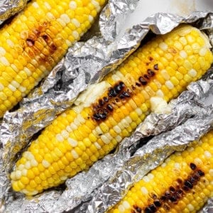 Three ears of Blackstone corn on the cob in aluminum foil.