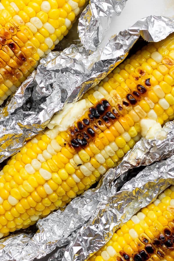 Three ears of Blackstone corn on the cob in aluminum foil.