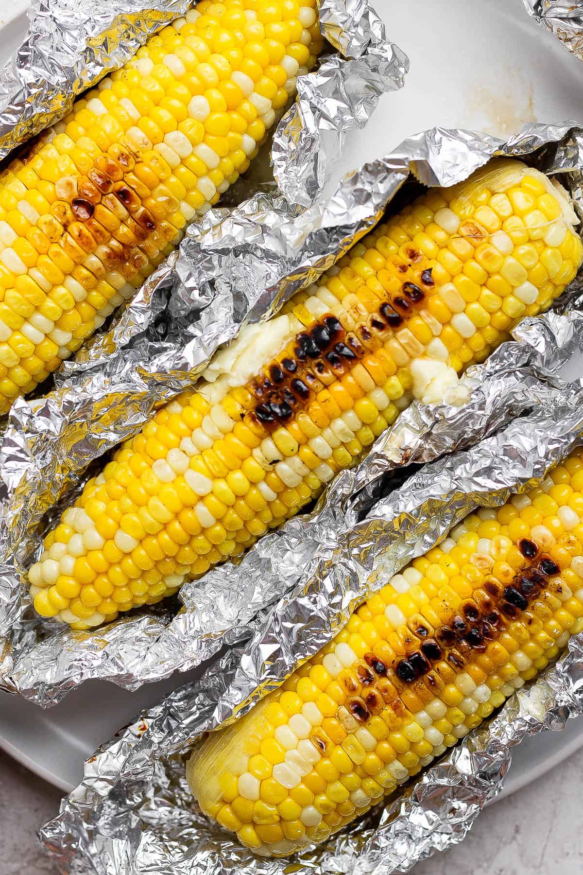 Three ears of Blackstone corn on the cob sitting on a plate.