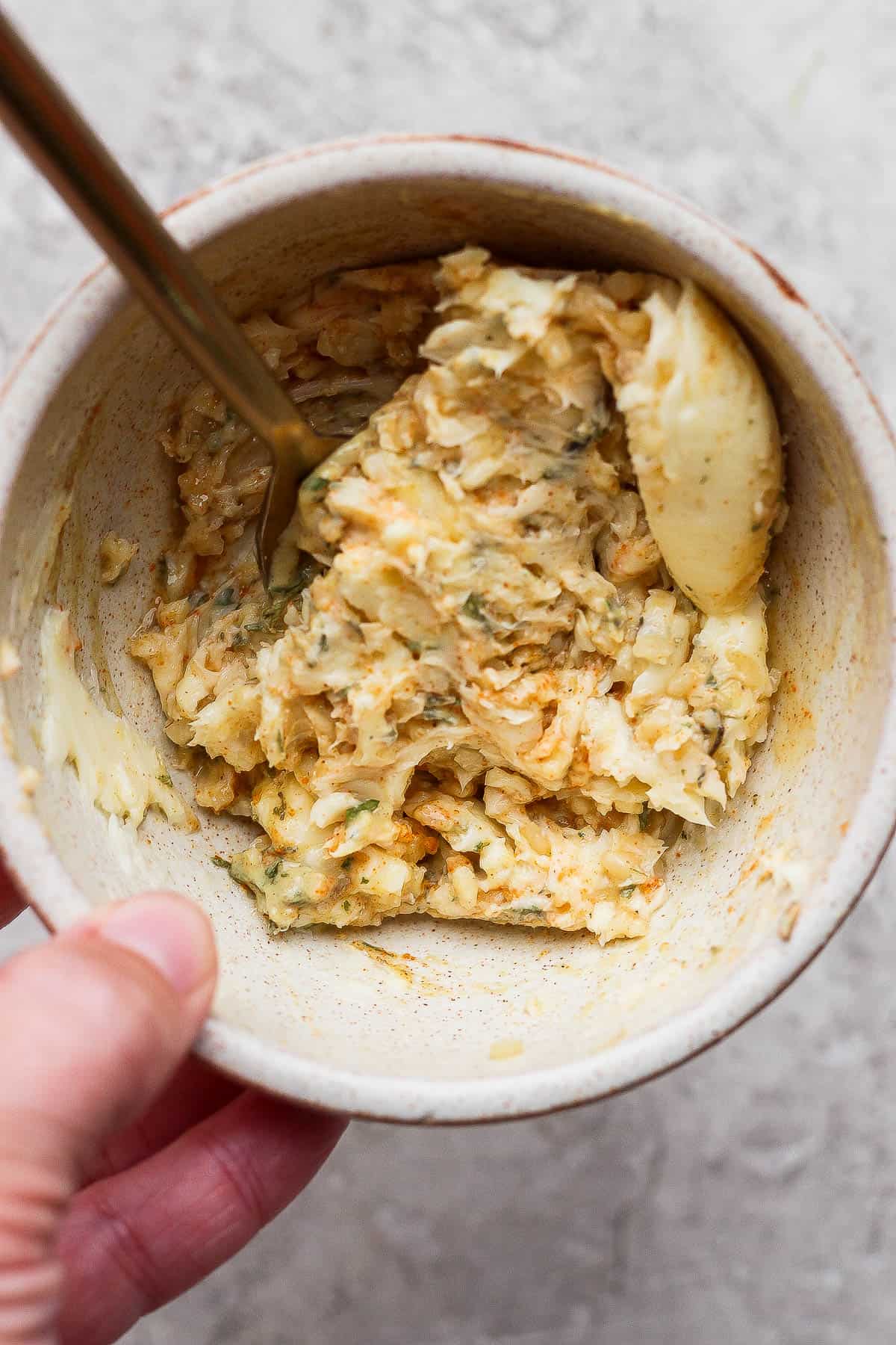 Cowboy butter for Blackstone steak bites in a bowl with a gold fork.