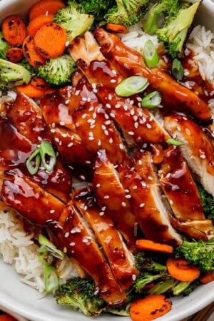 Blackstone teriyaki chicken over rice in a large white bowl.