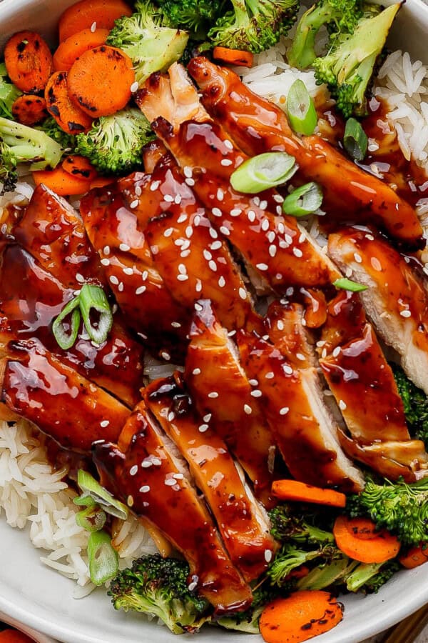 Blackstone teriyaki chicken over rice in a large white bowl.