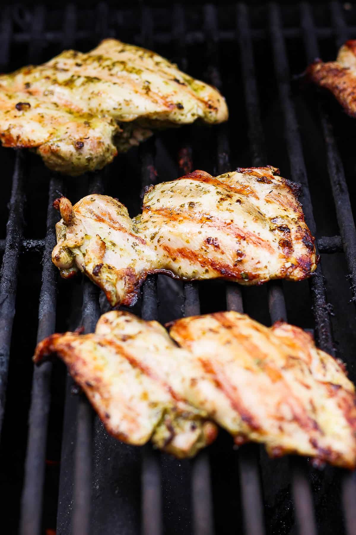 Grilled cilantro lime chicken thighs fully cooked on the grill.