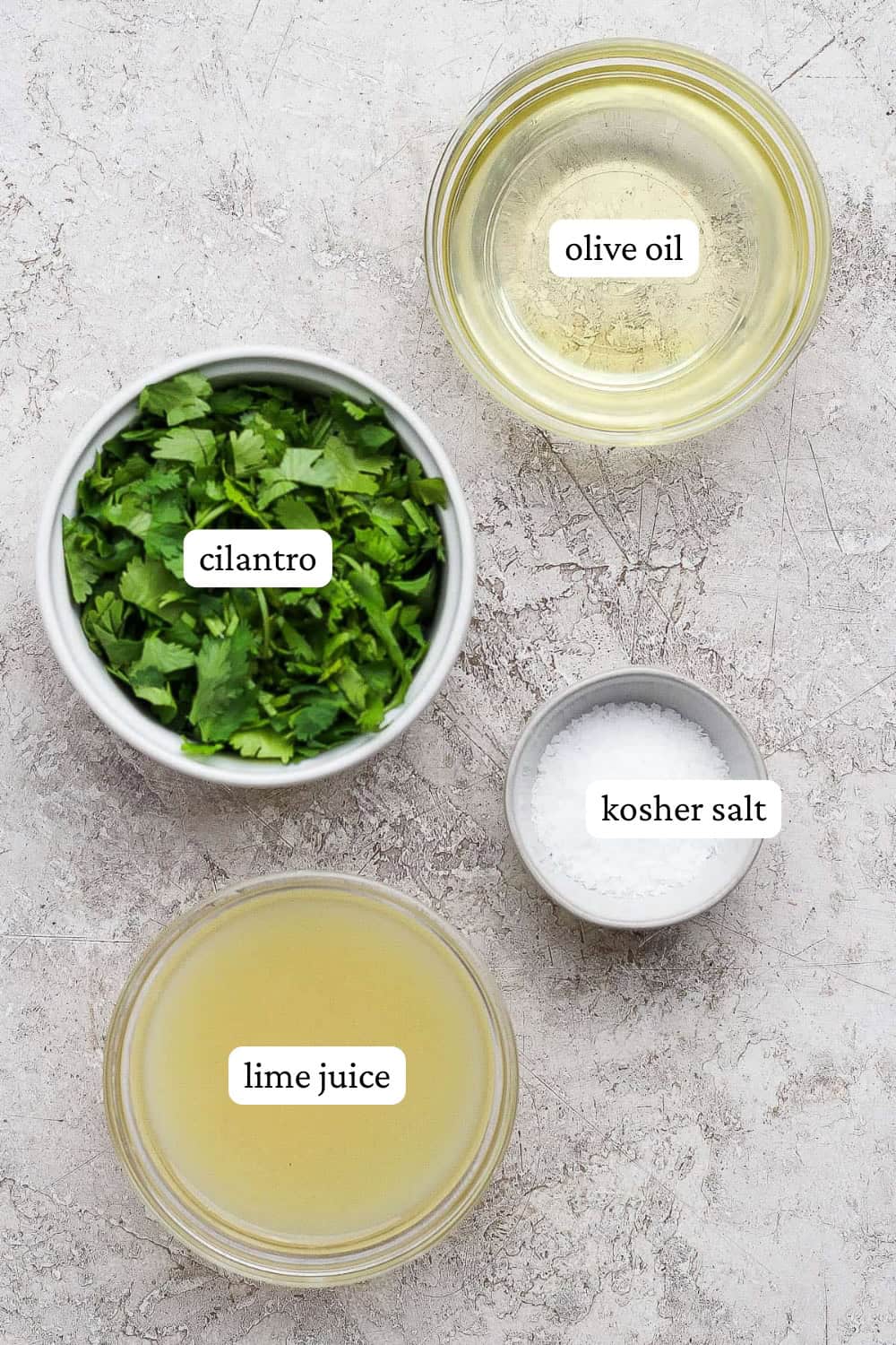 Cilantro lime marinade ingredients in separate bowls with labels.