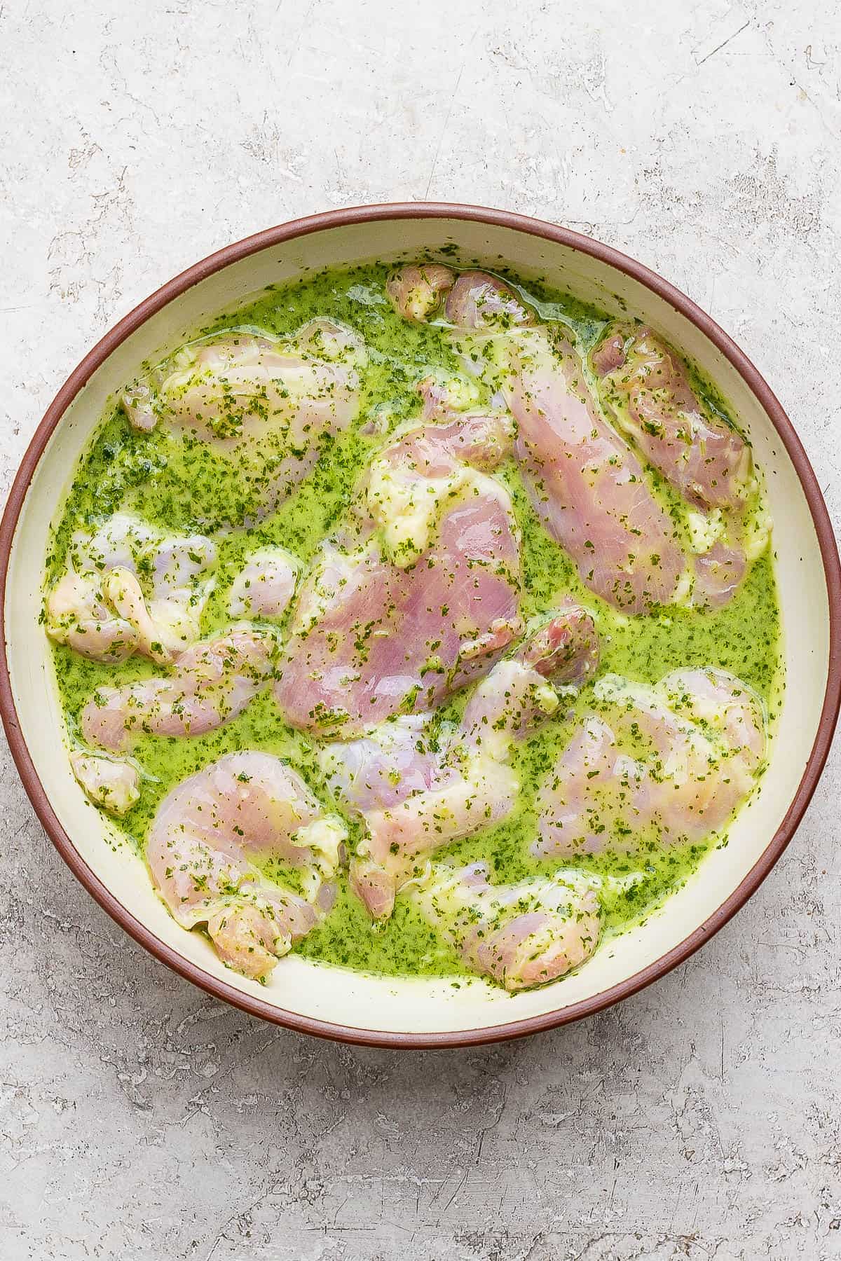 Cilantro lime marinated chicken thighs in a large bowl after 30 minutes.