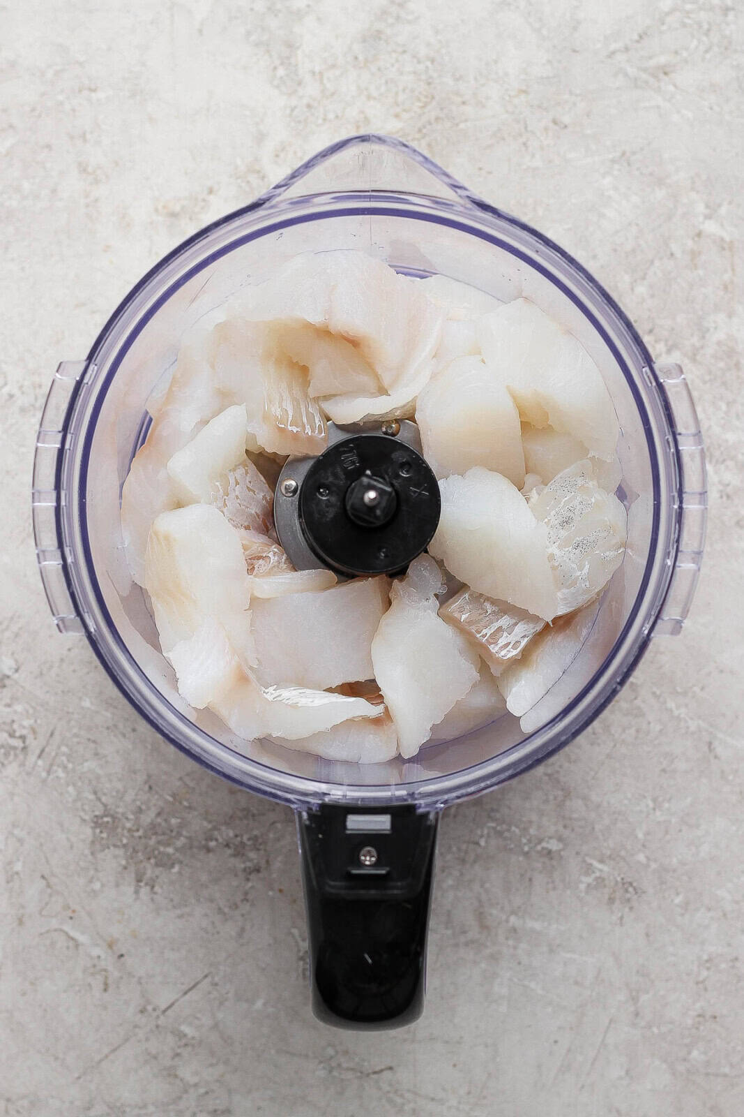 Fresh cod in large chunks in a food processor.