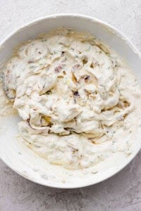 Fully mixed smoked onion dip in a white bowl.