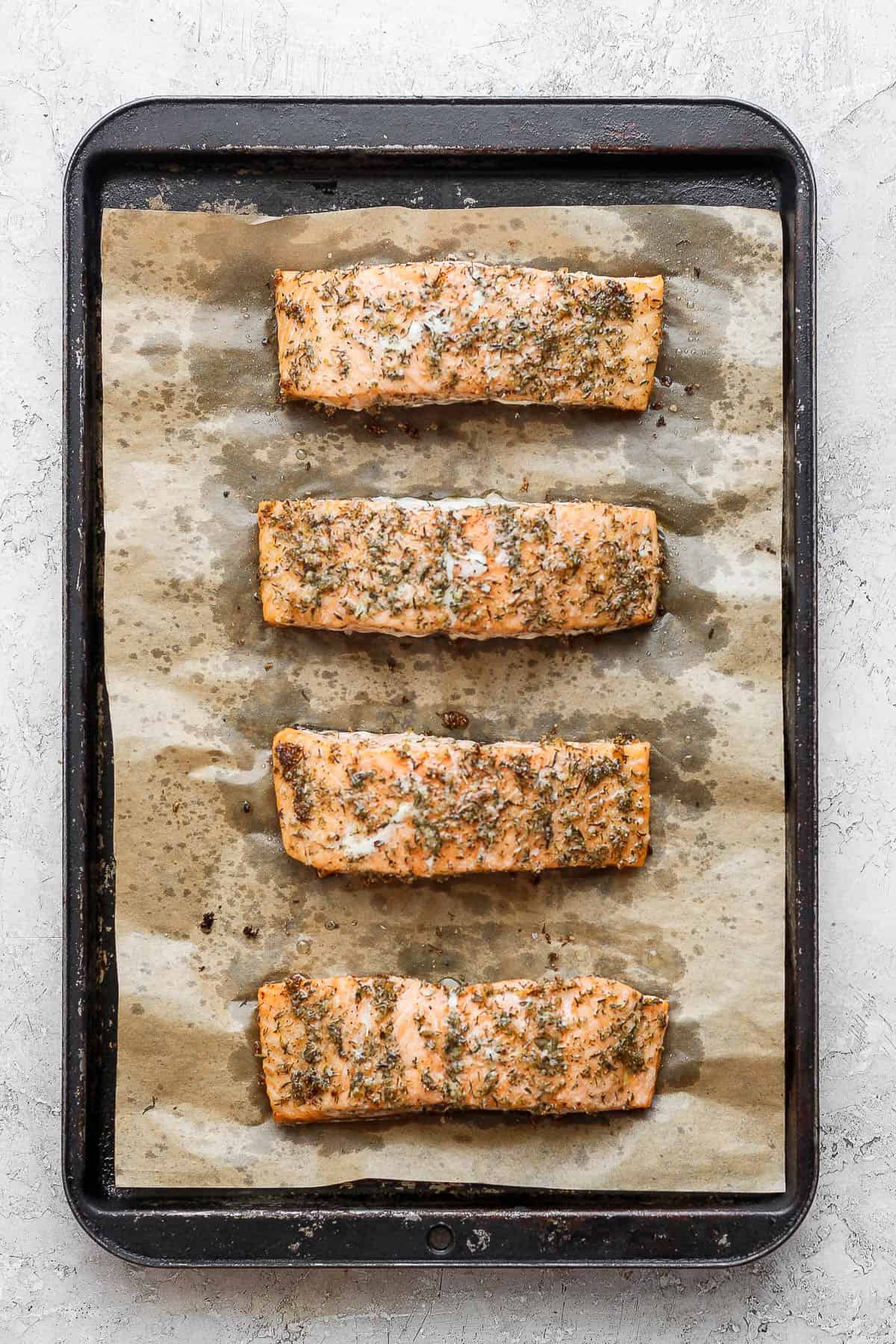 Four baked salmon fillets with salmon seasoning.