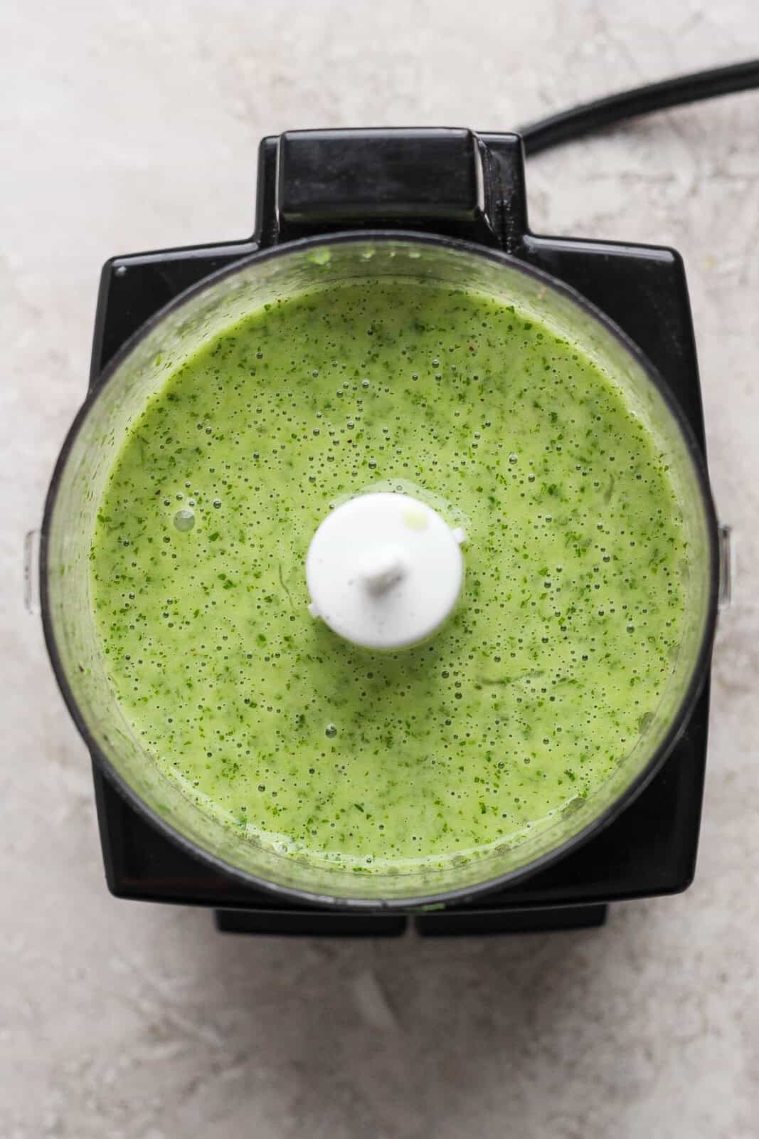 Cilantro lime sauce in a food processor for making crockpot cilantro lime chicken.