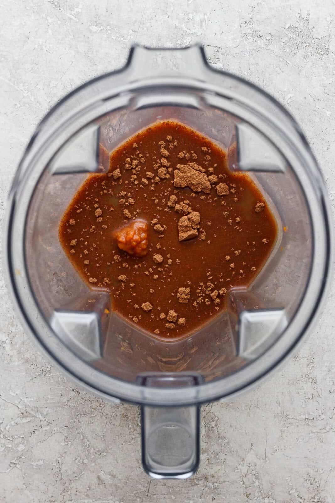 Dairy free pumpkin spice latte ingredients in a blender before blending.