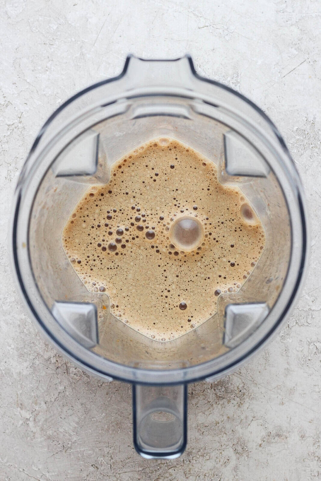 A fully blended dairy free pumpkin spice latte in a blender.