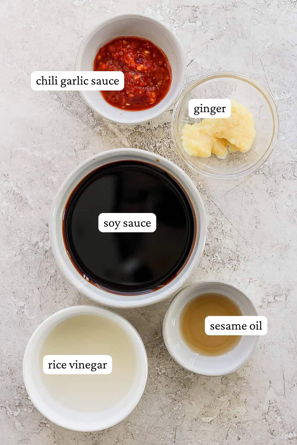 Ingredients for fried rice sauce in separate bowls with labels.