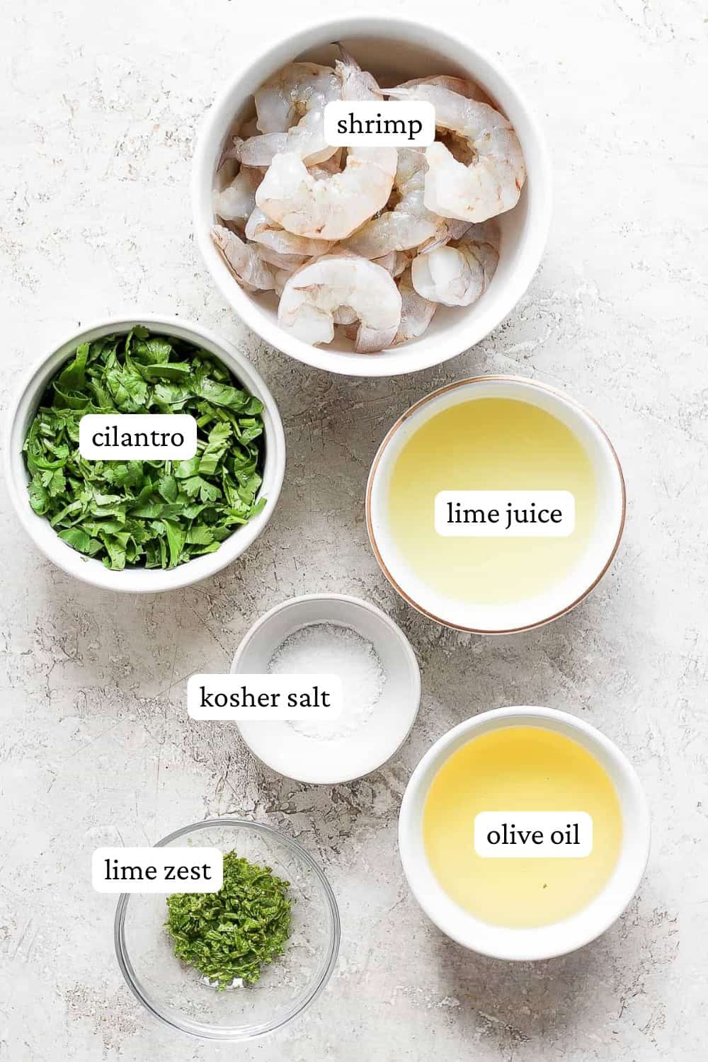 Ingredients for cilantro lime shrimp in separate bowls with labels.