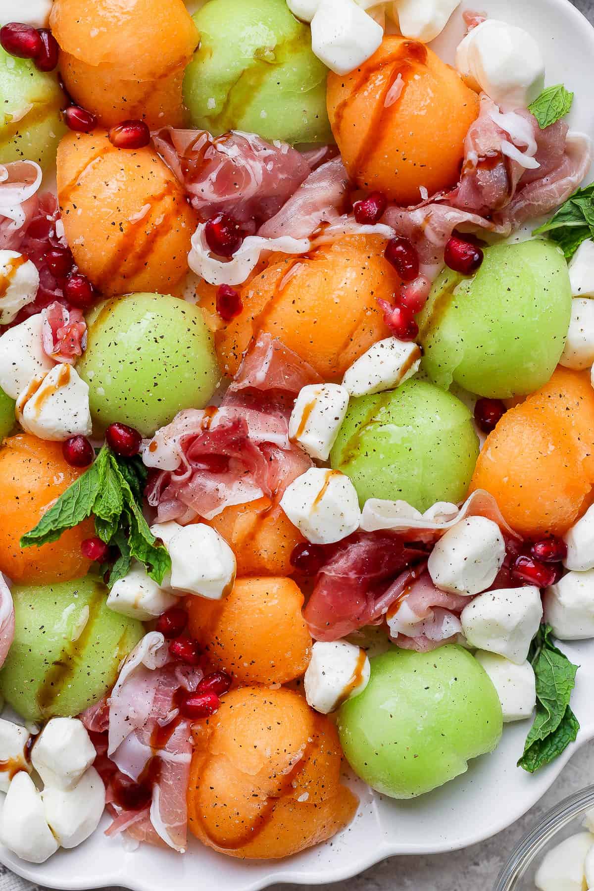 Caprese melon salad fully assembled on a large platter.