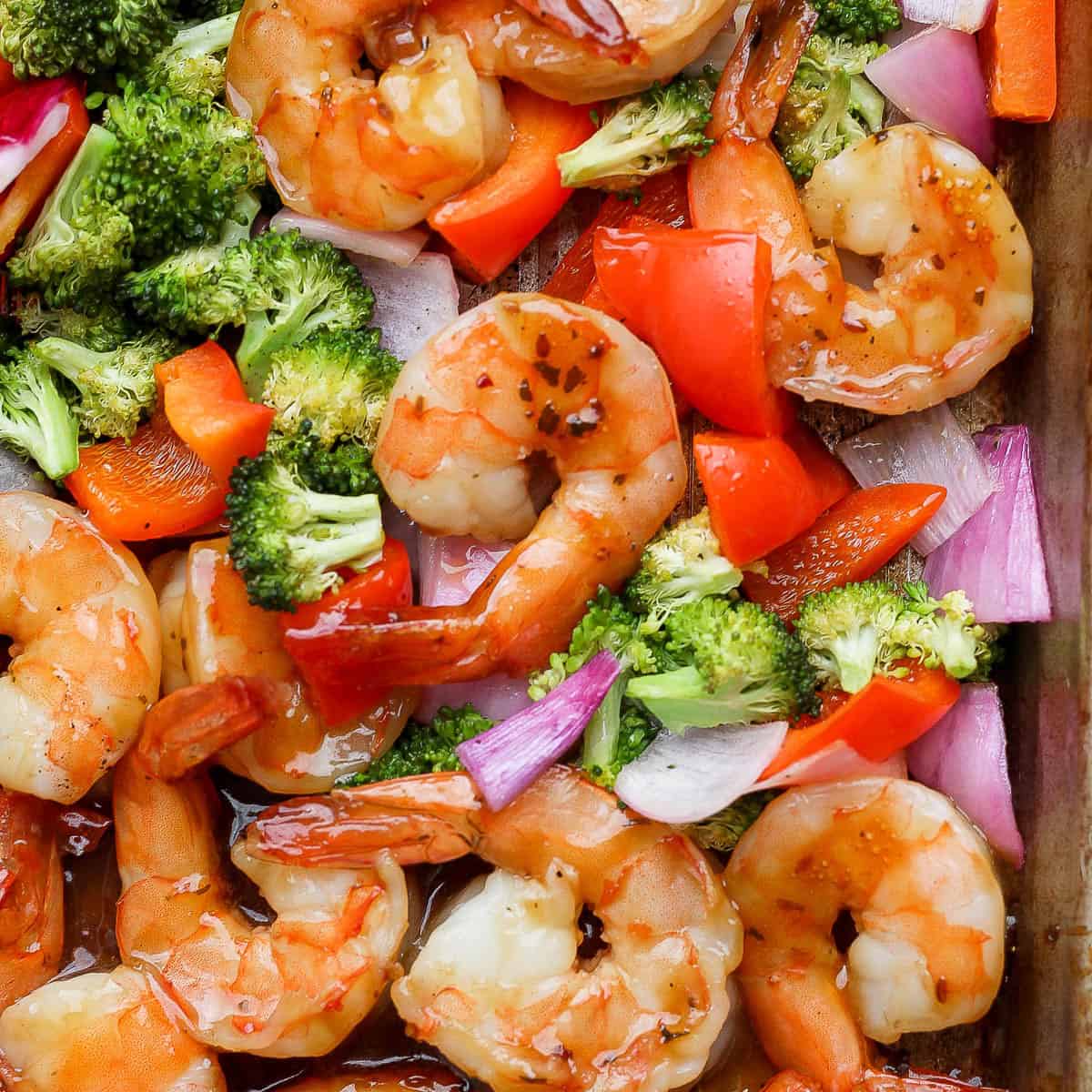 Sheet pan shrimp dinner fully cooked on a baking sheet.