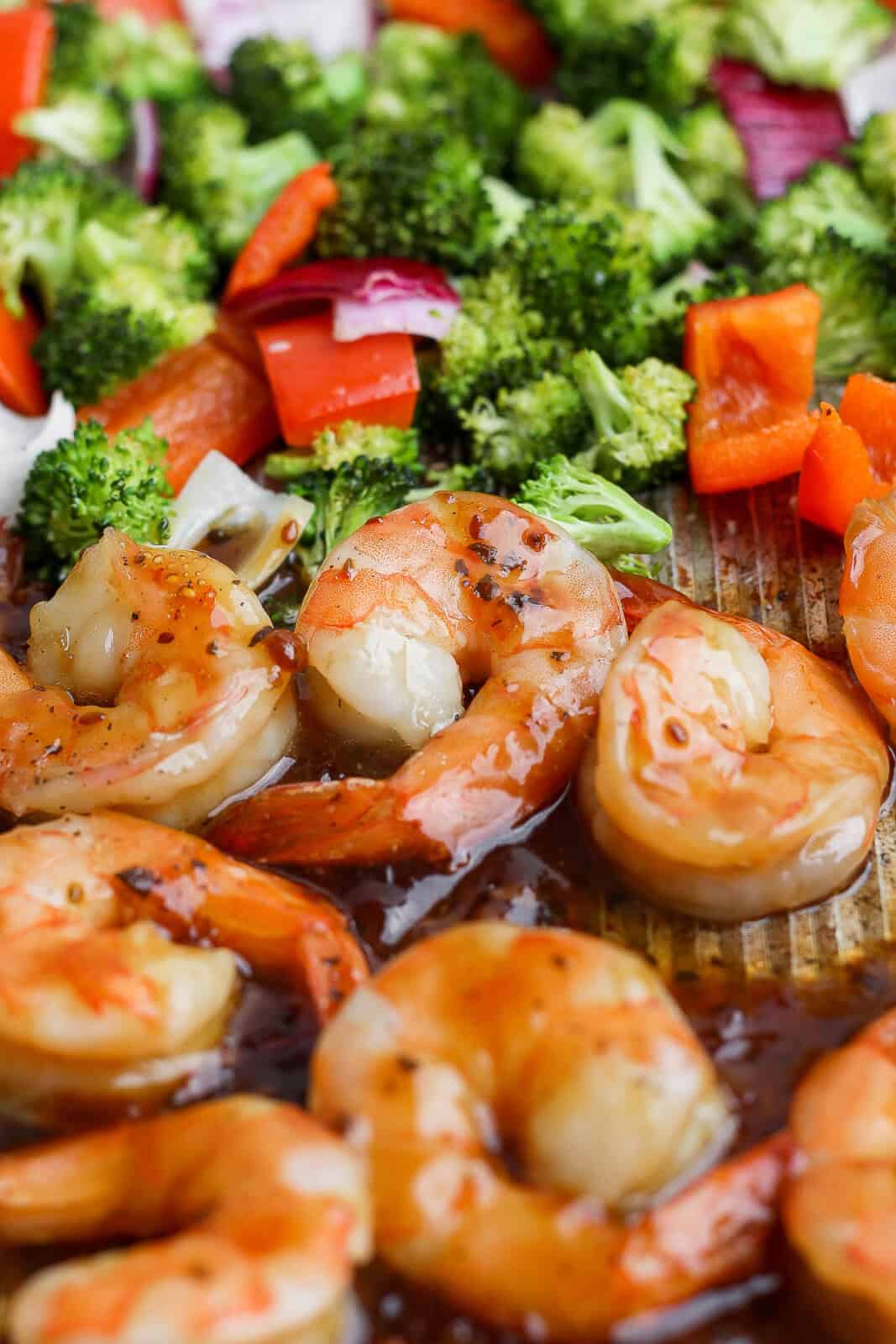 Teriyaki shrimp sheet pan dinner on the sheet pan with shrimp on one side and veggies on the other.