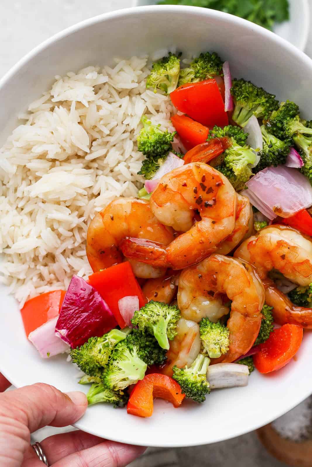 Teriyaki shrimp sheet pan dinner in a white bowl with rice.