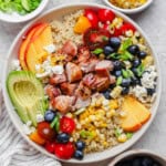 Fully assembled summer quinoa salad in a white bowl.