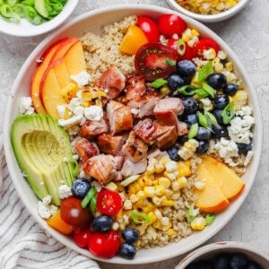 Fully assembled summer quinoa salad in a white bowl.