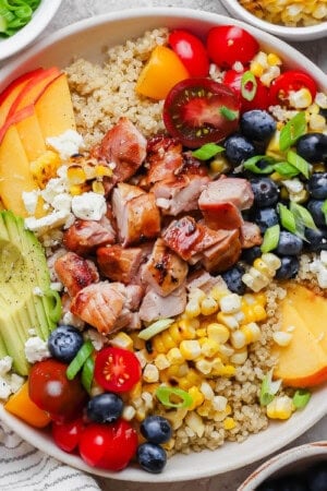 Fully assembled summer quinoa salad in a white bowl.