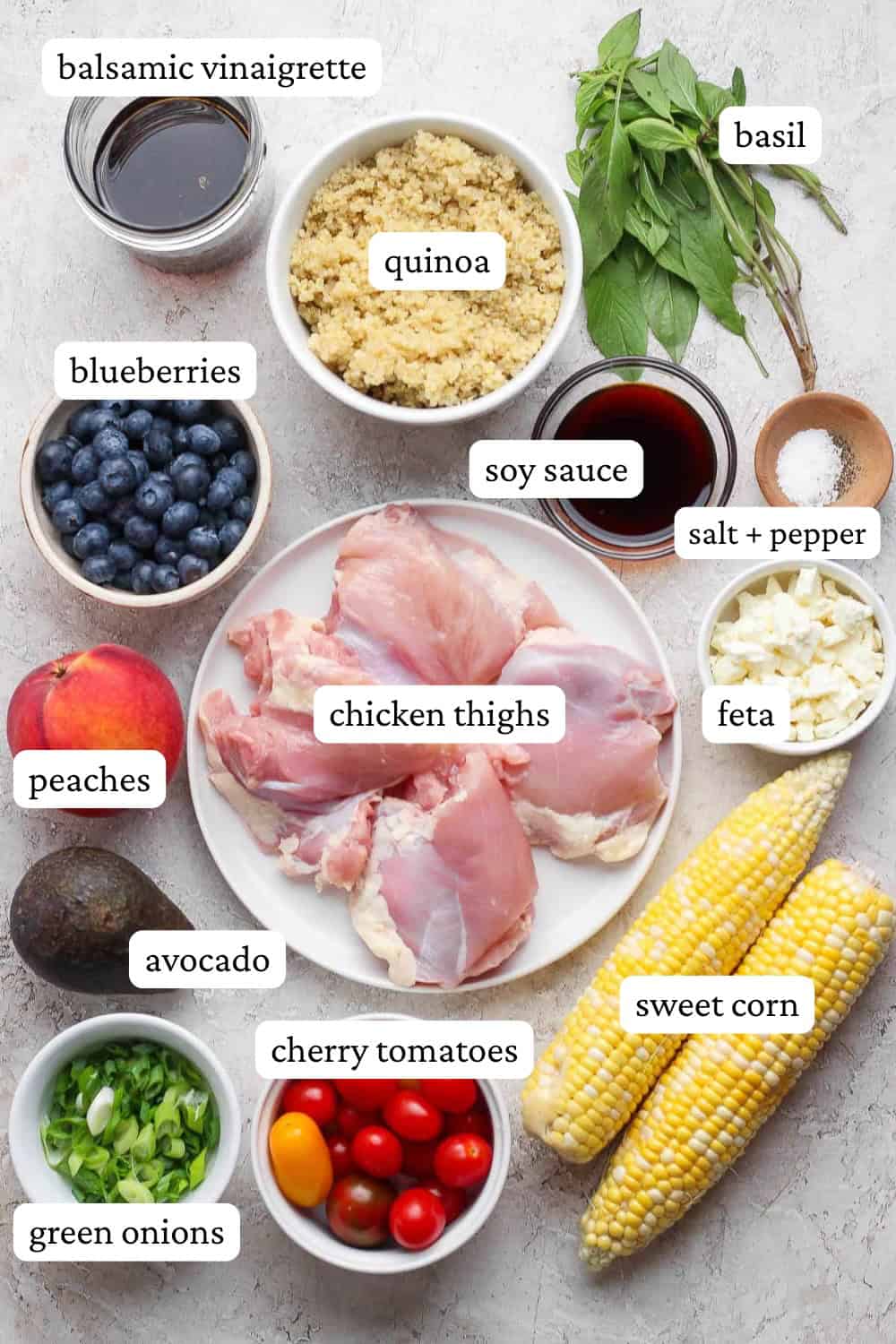 Ingredients for summer quinoa salads in separate bowls with labels.
