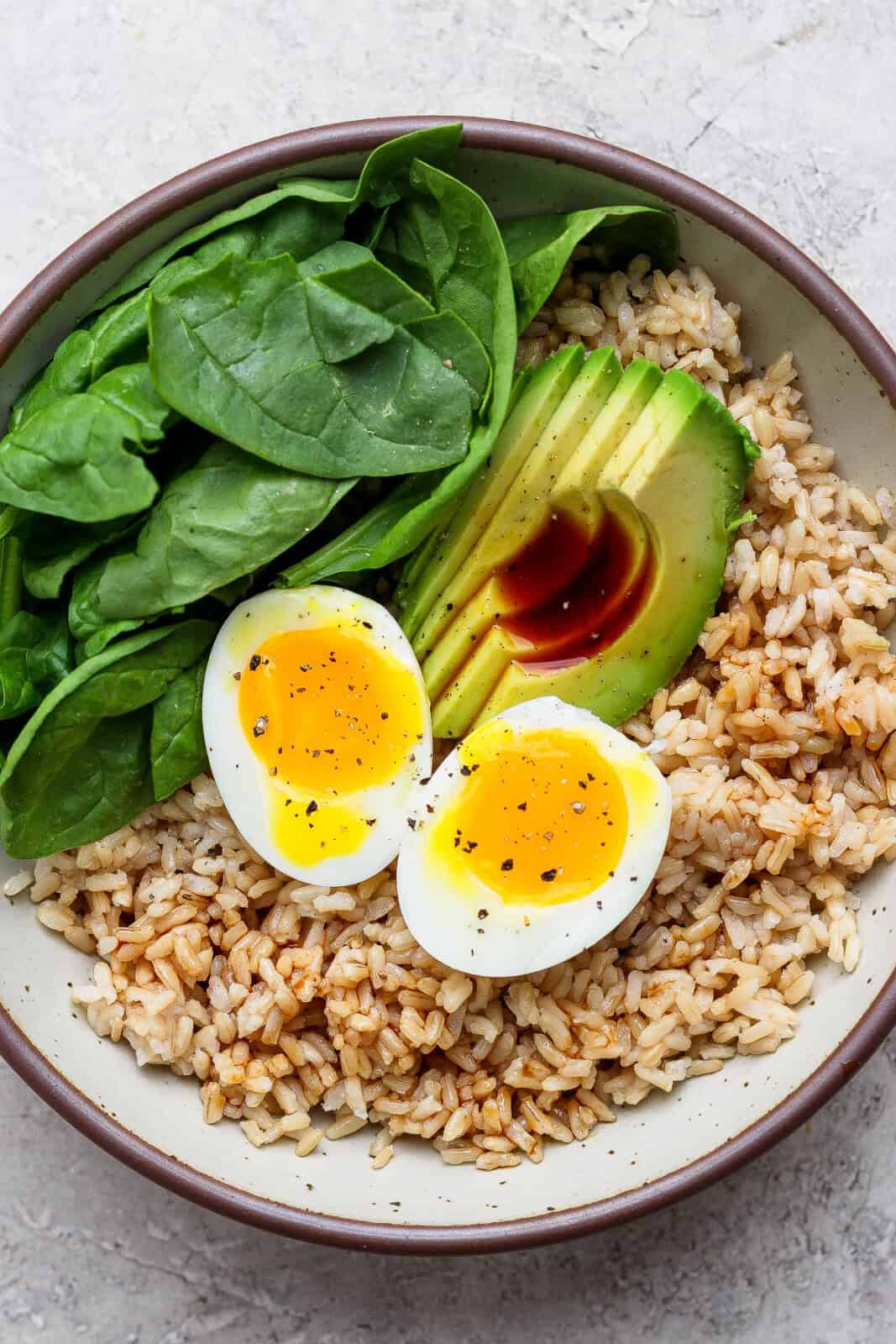Soy sauce added to an avocado egg bowl.