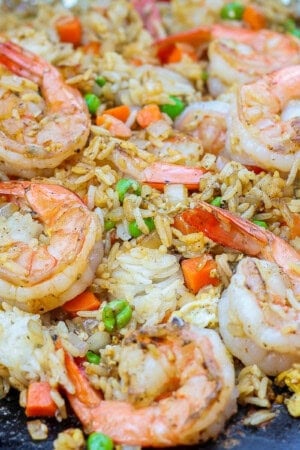 Blackstone shrimp fried rice cooking on the hot griddle.