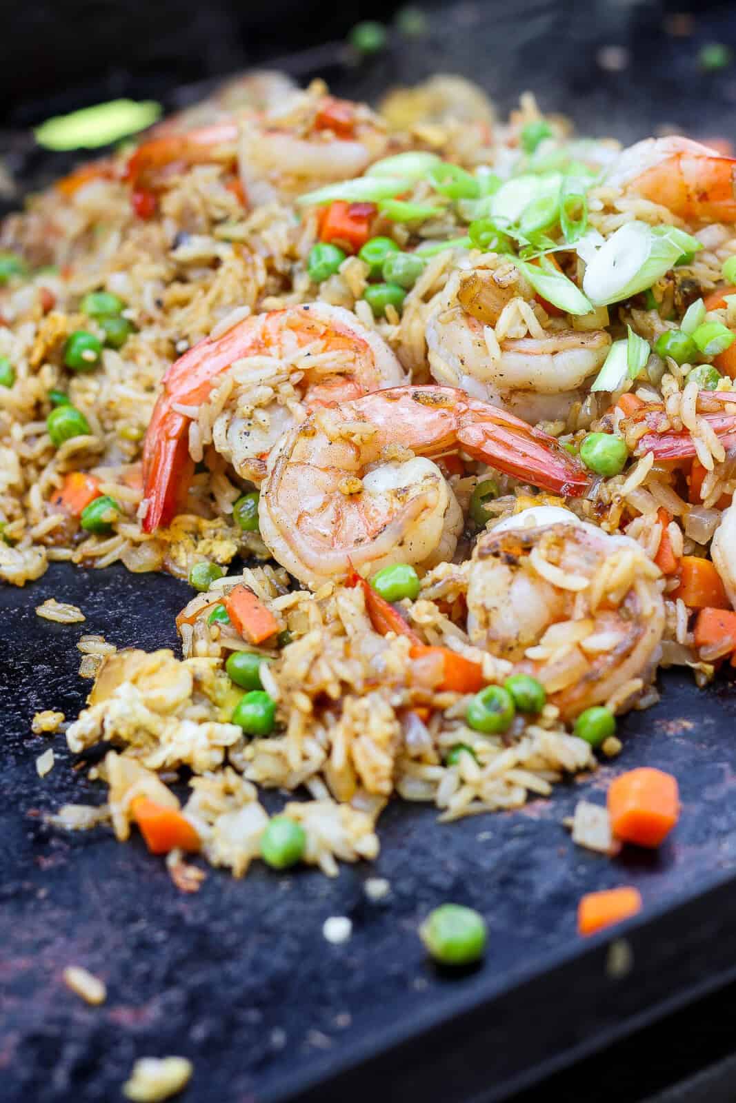 Blackstone shrimp fried rice cooking on the hot cooktop.