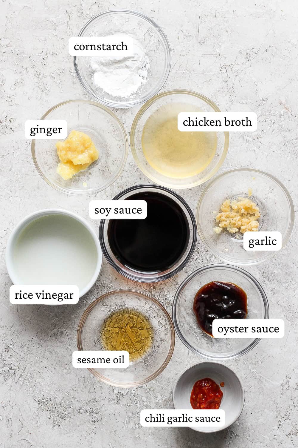 Ingredients for chow mein sauce in separate bowls with labels.