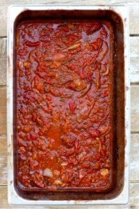 A large batch of homemade marinara sauce in a large aluminum pan.