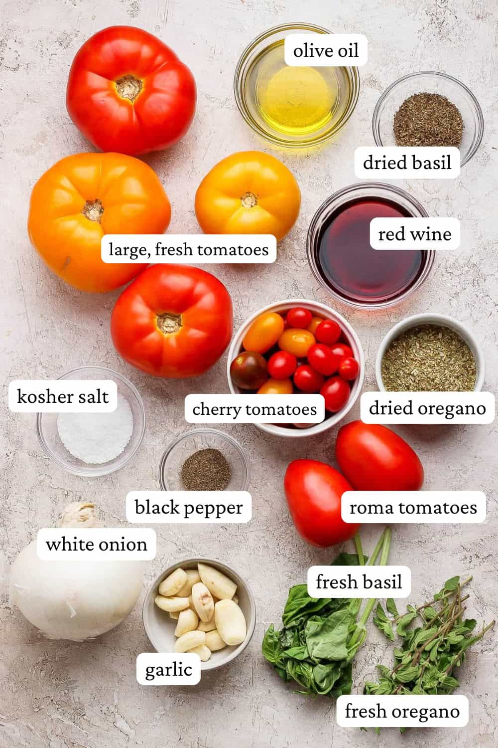 Ingredients for the best homemade marinara sauce on the counter and in bowls with labels.