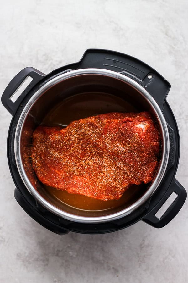 Instant Pot pork shoulder in the pot and ready to be cooked.