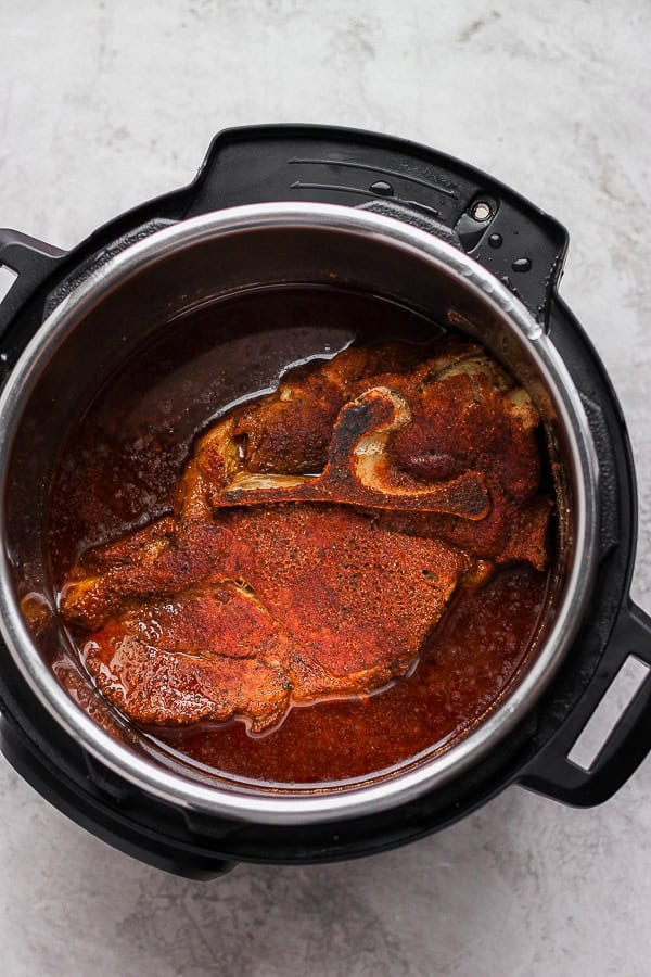 A fully cooked Instant Pot pork shoulder still in the pot.