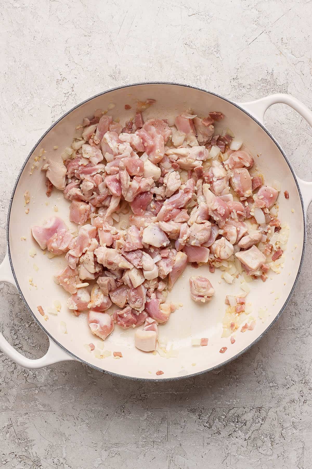 One-inch chicken thigh pieces added to skillet to make marry me chicken orzo.