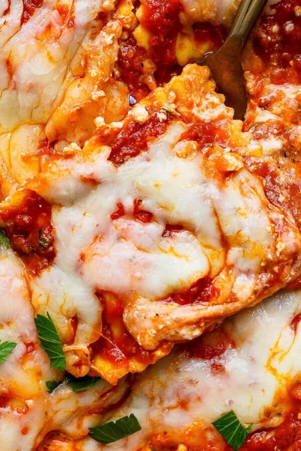 Million dollar ravioli casserole with a fork in the side.