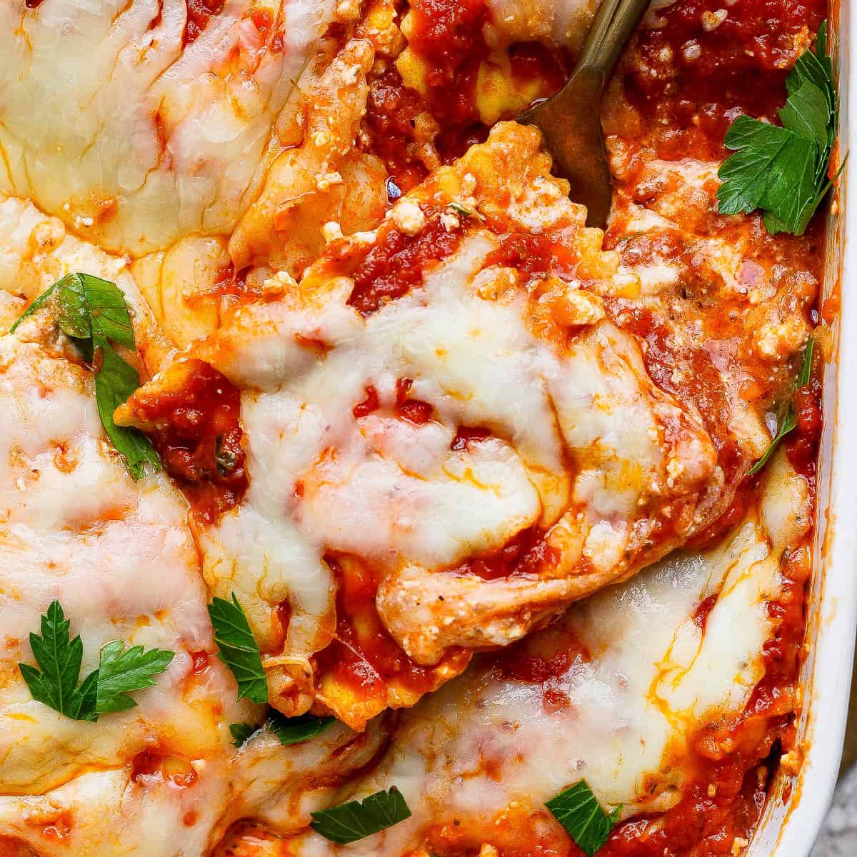Million dollar ravioli casserole with a fork in the side.