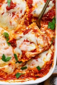 A fork lifting a piece of ravioli from a million dollar ravioli casserole.