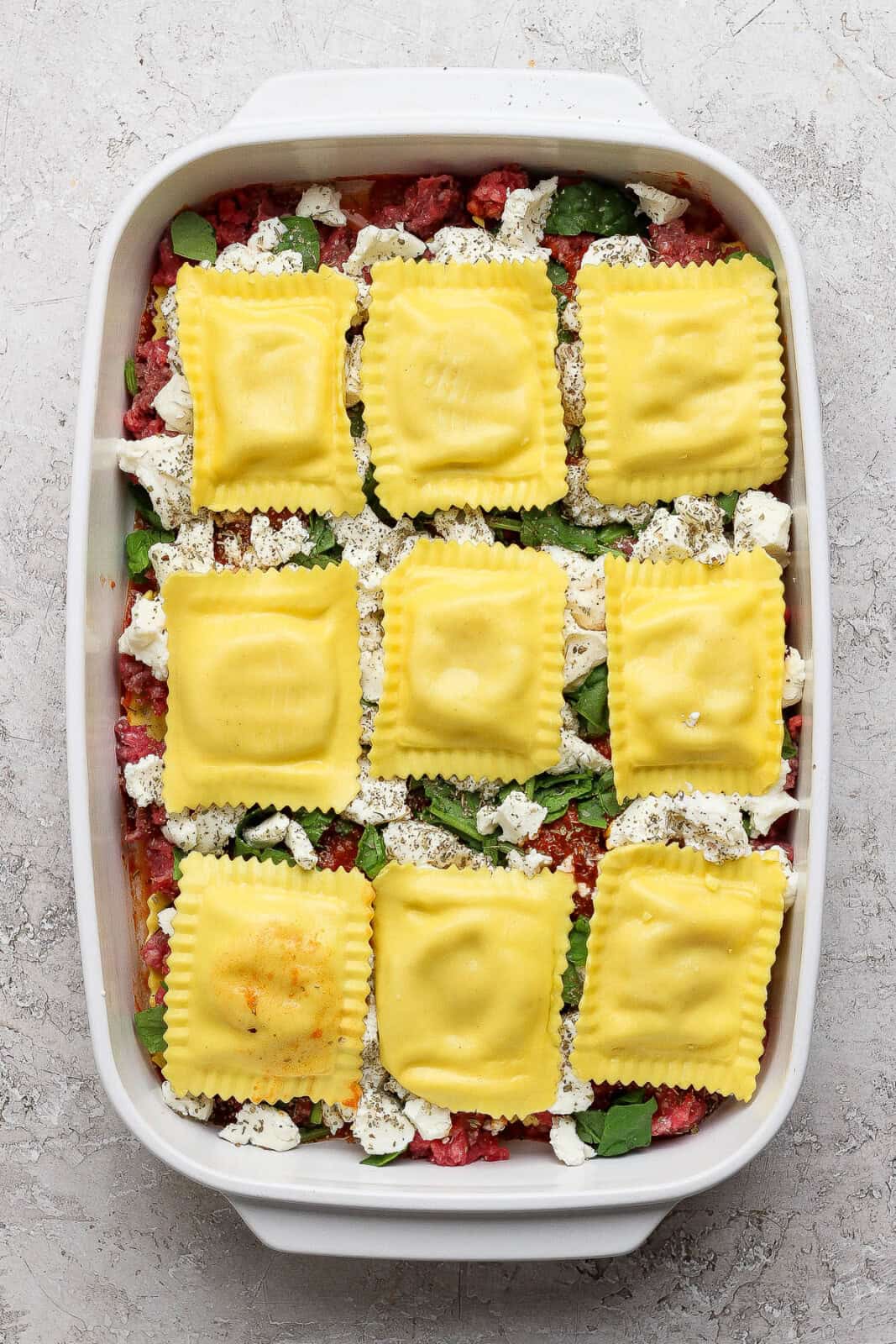 Nine more ravioli added to a million dollar ravioli casserole.