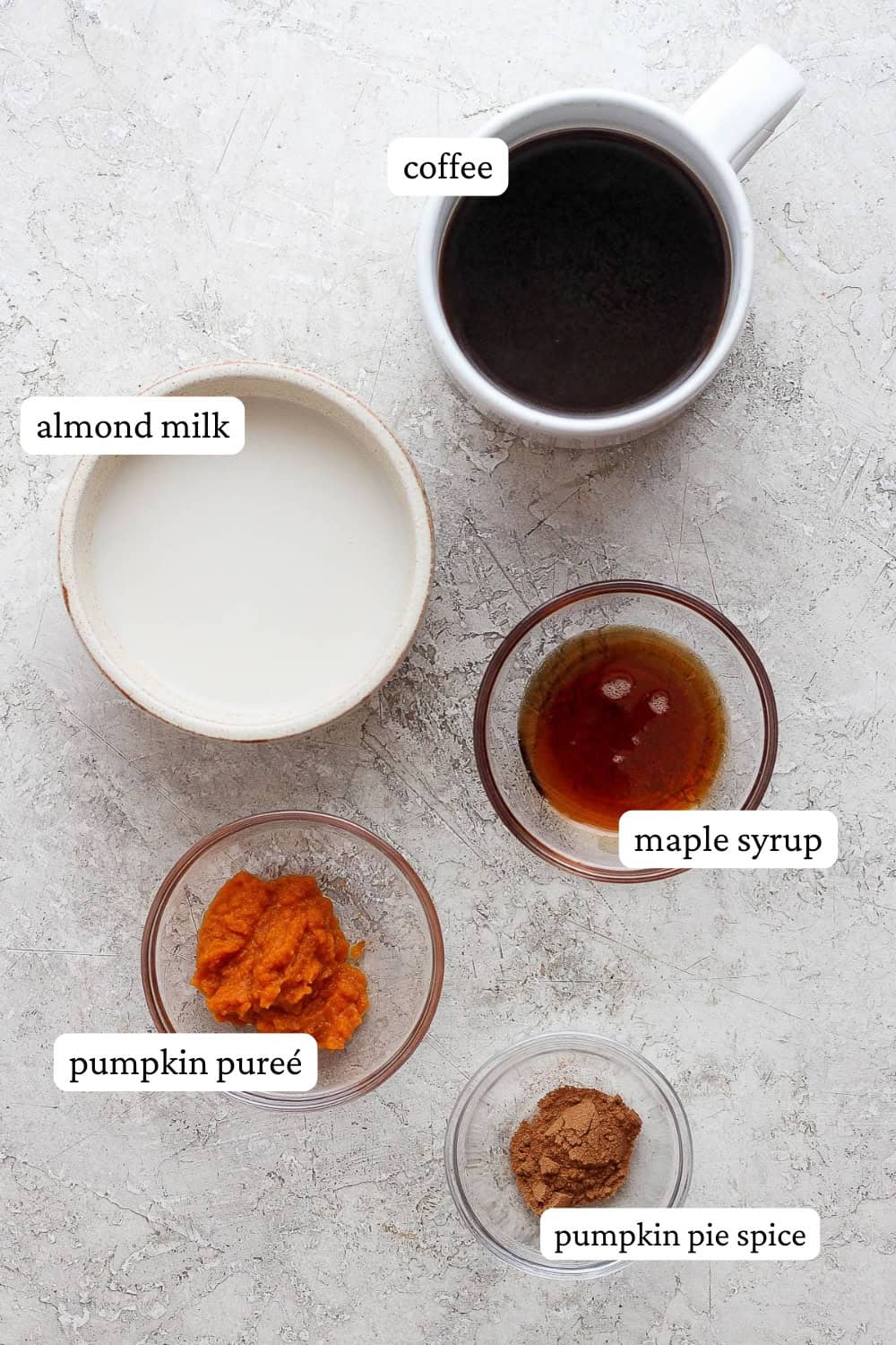 Dairy free pumpkin spice latte ingredients in separate bowls with labels.