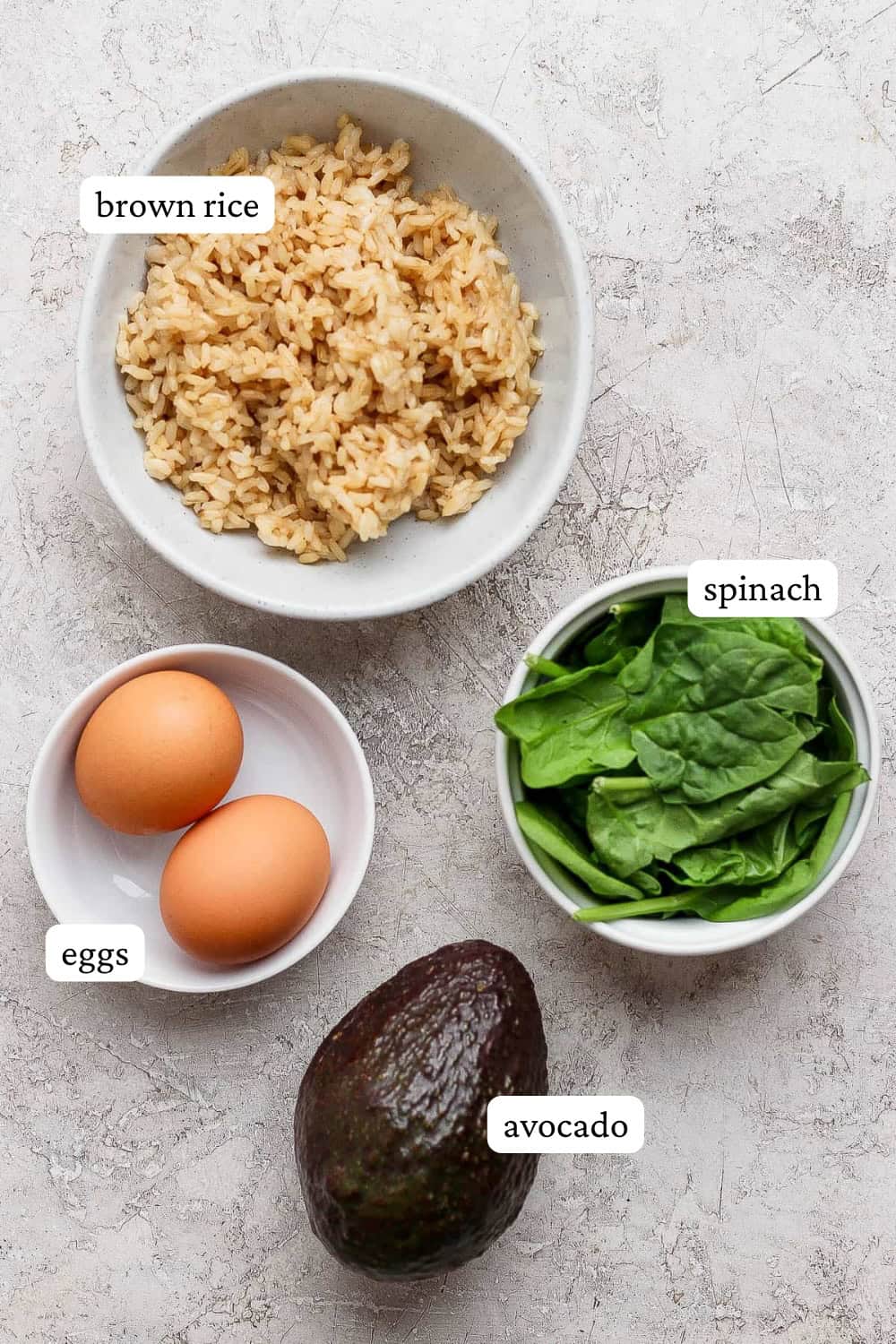 Ingredients for an avocado egg bowl in separate bowls with labels.