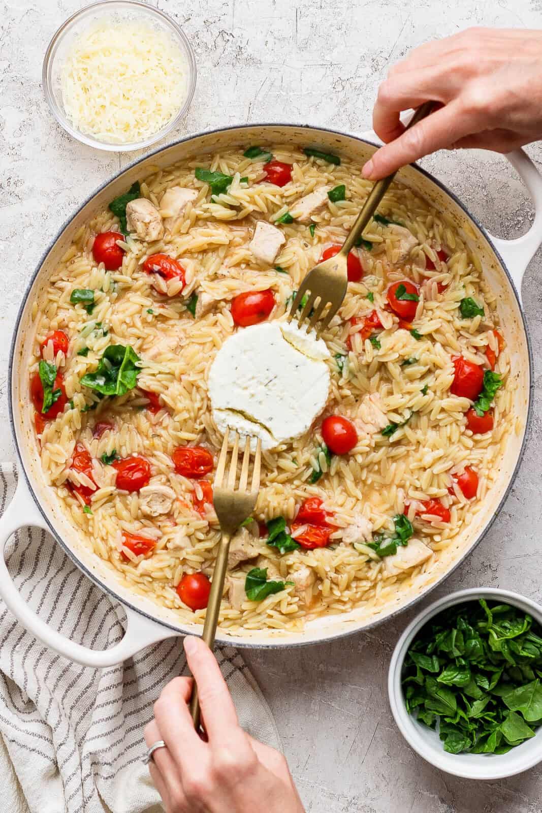 Boursin cheese added to the middle of the fully cooked orzo for boursin orzo with chicken.