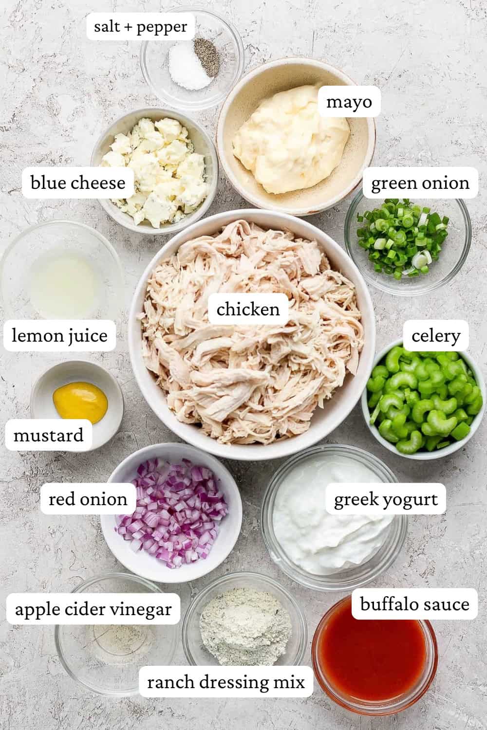 Ingredients for buffalo ranch chicken salad in separate bowls with labels.